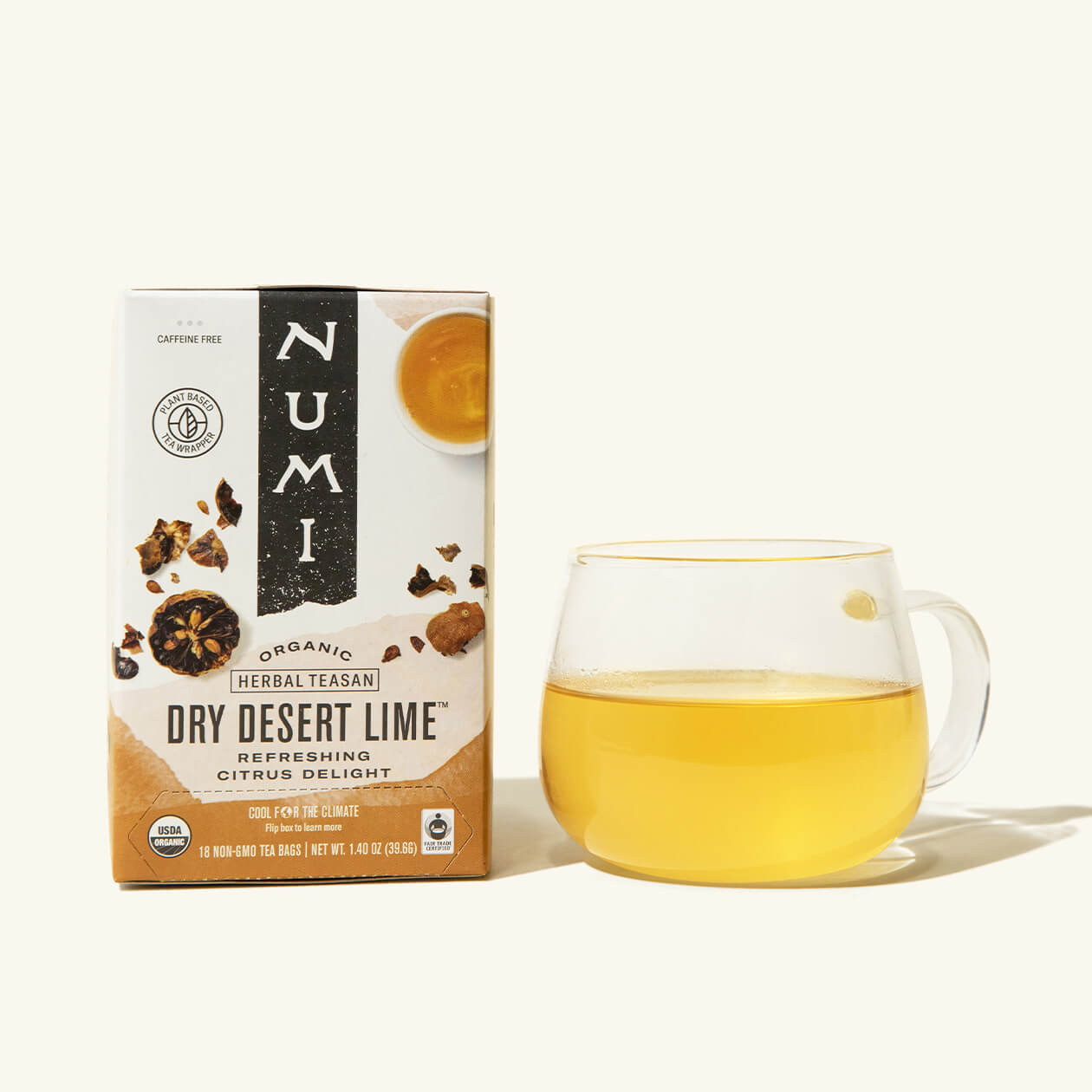 A box of Numi's Dry Desert Lime next to a brewed cup of tea in a clear cup