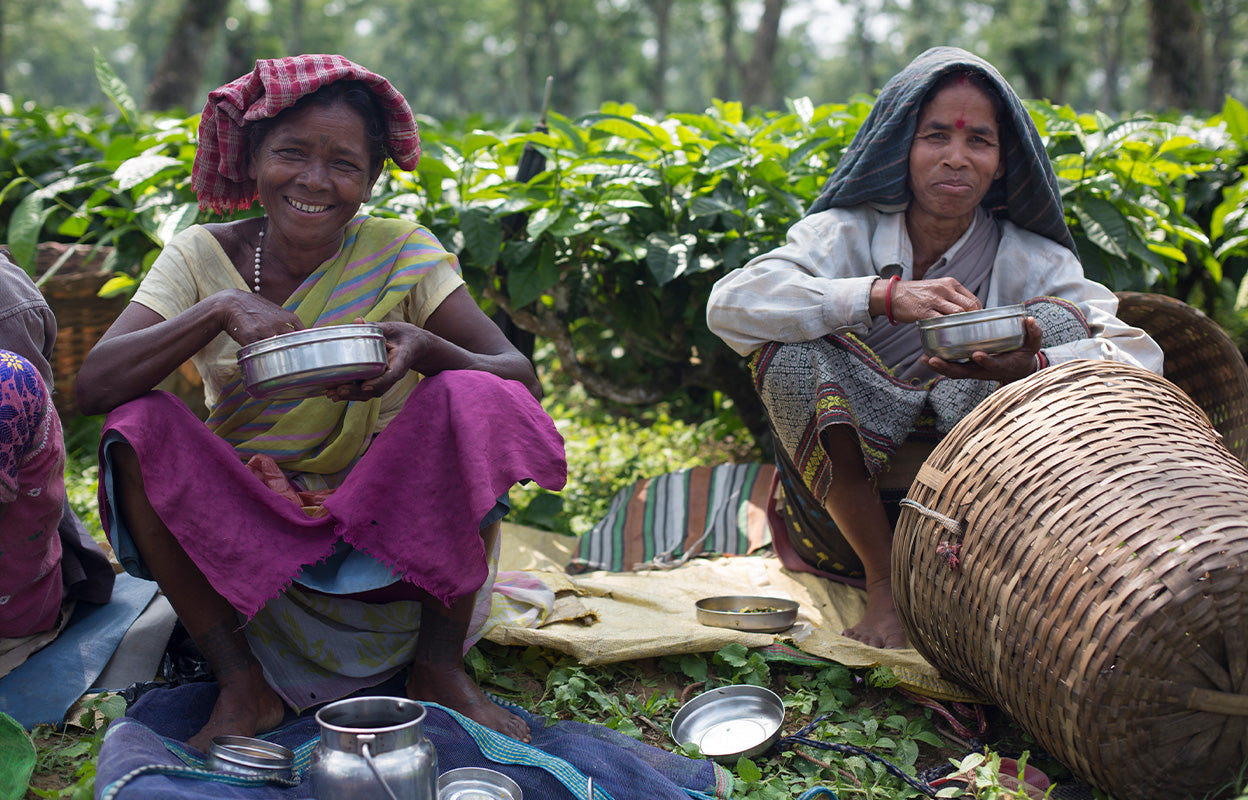 Indian tea farmers enjoying cookware provided by Fair Trade funds