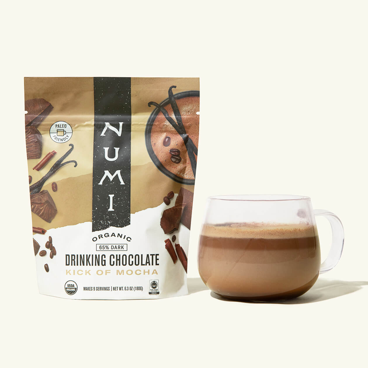 A pouch of Numi organic Drinking Chocolate, Kick Of Mocha Flavor, next to a cup of hot chocolate
