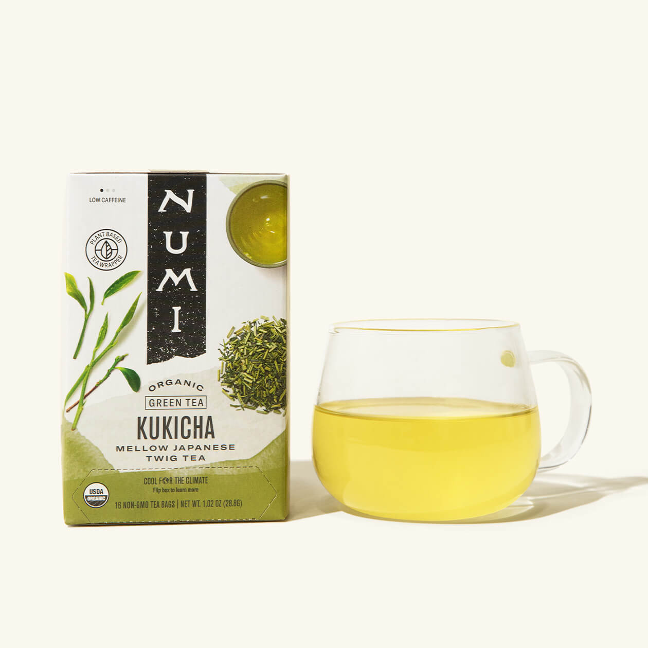 A box of Numi's Kukicha next to a brewed cup of tea in a clear cup