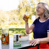 A woman enjoys an iced Numi Moroccan Mint tea with her healthy lunch