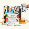 A Numi World of Tea gift with a ribbon, a cup of brewed tea, and a person holding the variety of tea bags that come in this gift