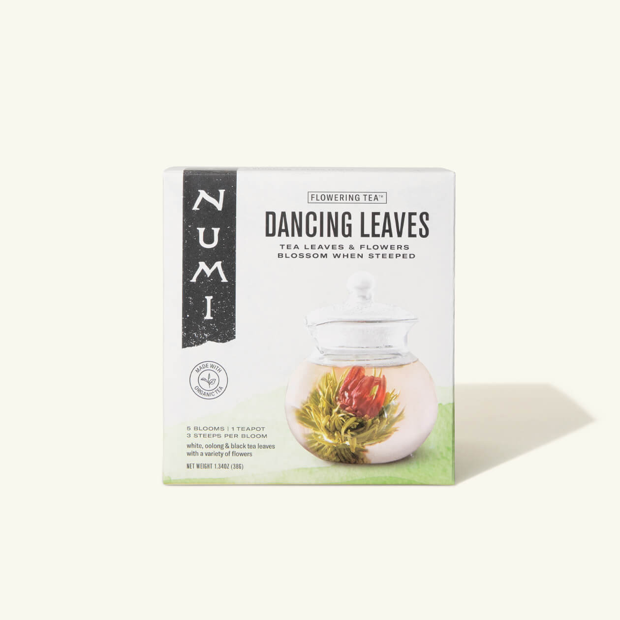A box of Numi's Dancing Leaves Flowering Tea box on a cream background