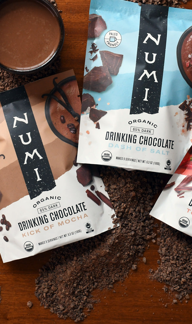 Numi Organic Fair Trade Drinking Chocolate with a hot cup of prepared chocolate
