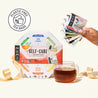 Numi tea sampler pack with a glass of tea and plastic-free tea bags label on a white background