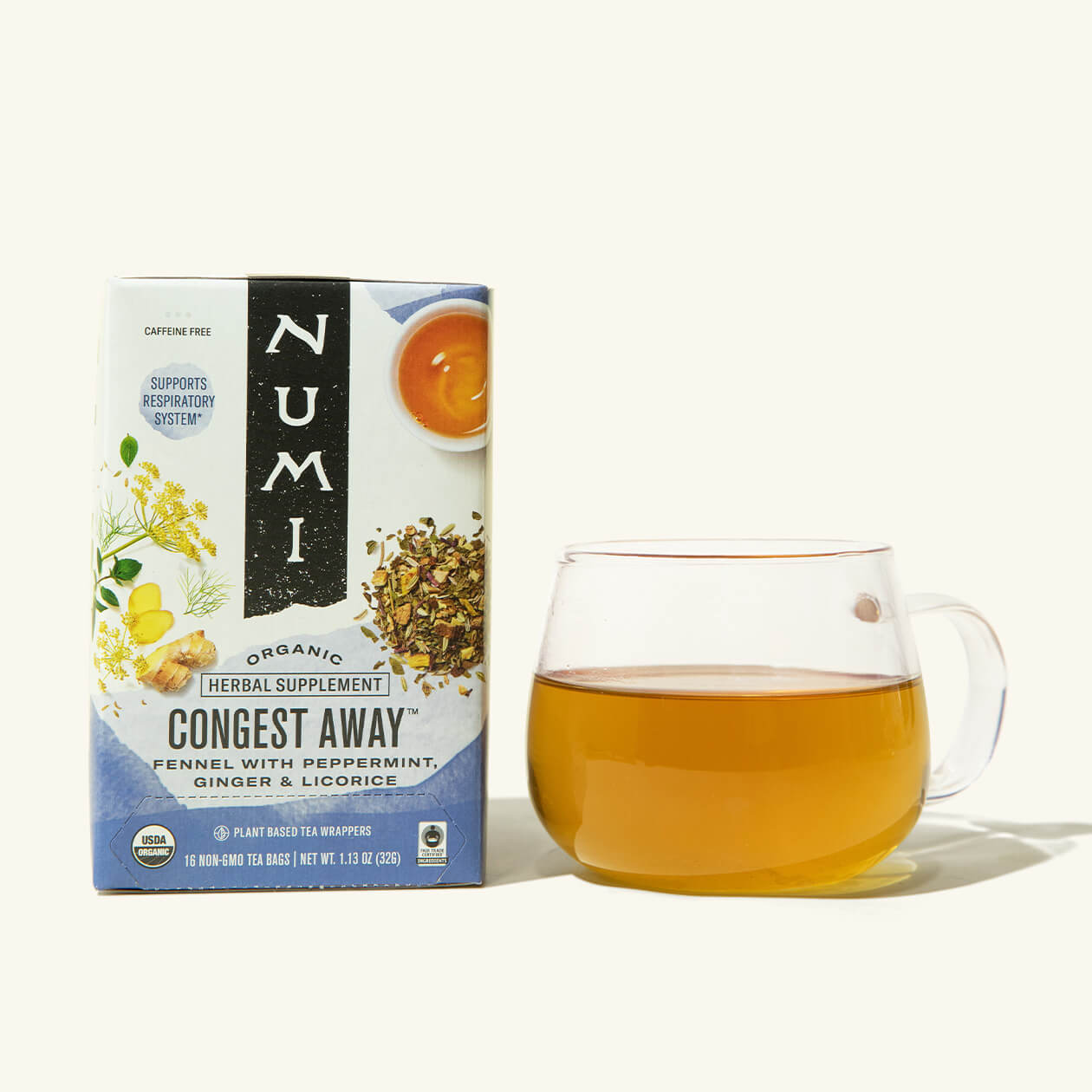 A box of Numi's Congest Away next to a brewed cup of tea in a clear cup