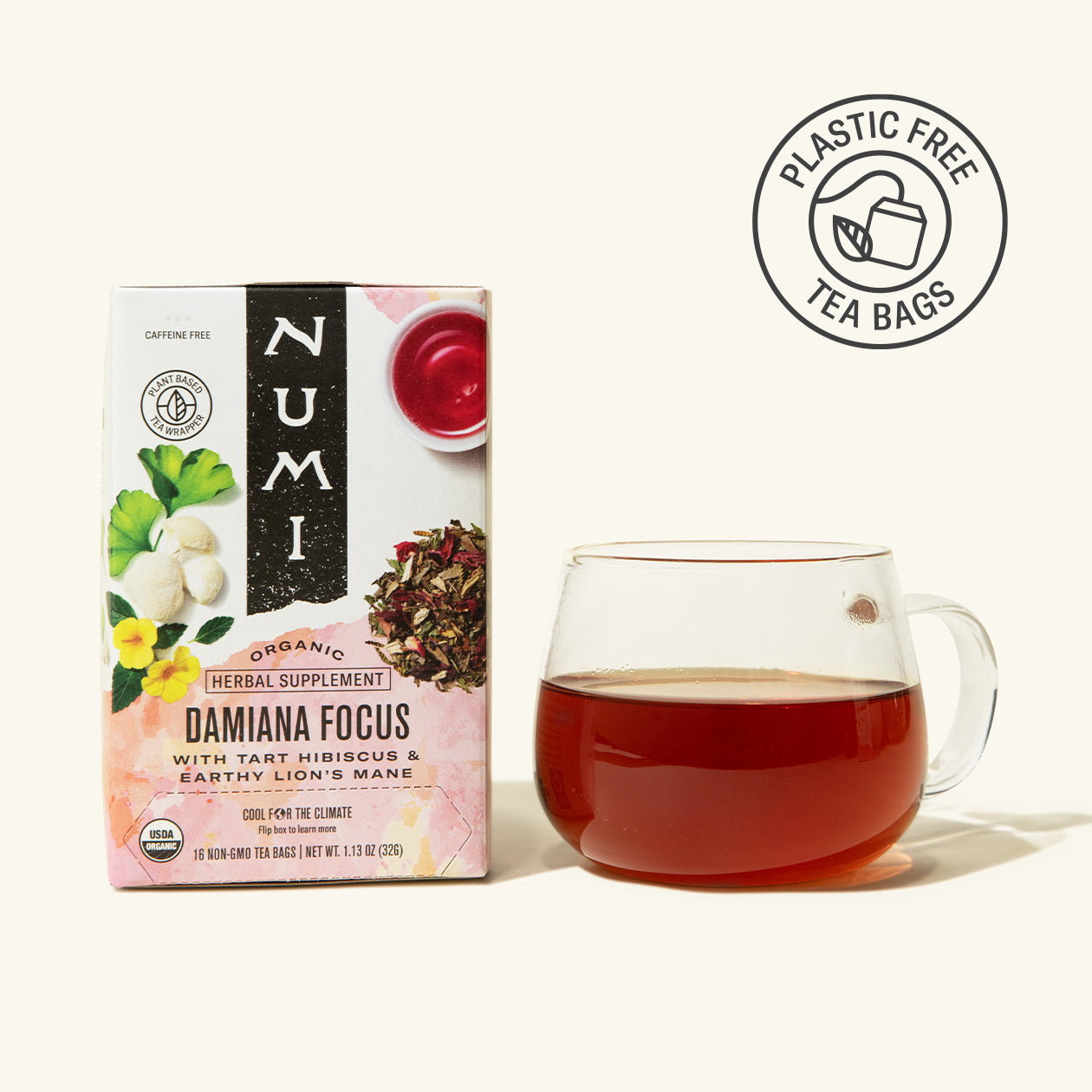 Numi Damaica Focus tea box with a glass of tea on a white background
