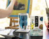 A person painting in their studio enjoys a cup of Numi's Damiana Relax tea