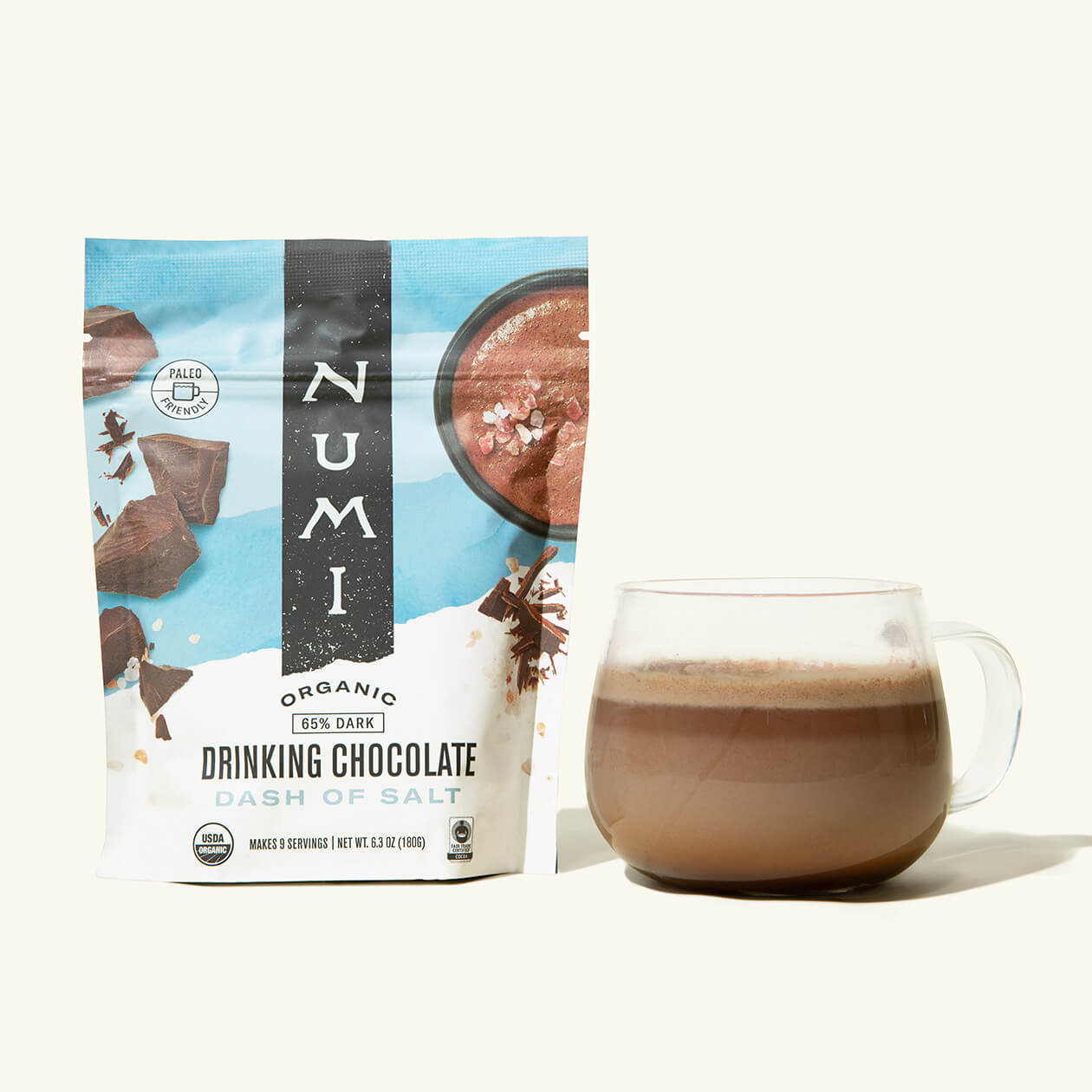 A pouch of Numi organic Drinking Chocolate, Dash of Salt Flavor, next to a cup of hot chocolate