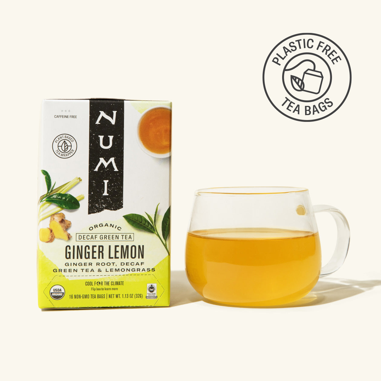A box of Numi Decaf Green Ginger Lemon Tea and a brewed cup on a white background