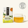 A box of Numi Decaf Green Ginger Lemon Tea and a brewed cup on a white background