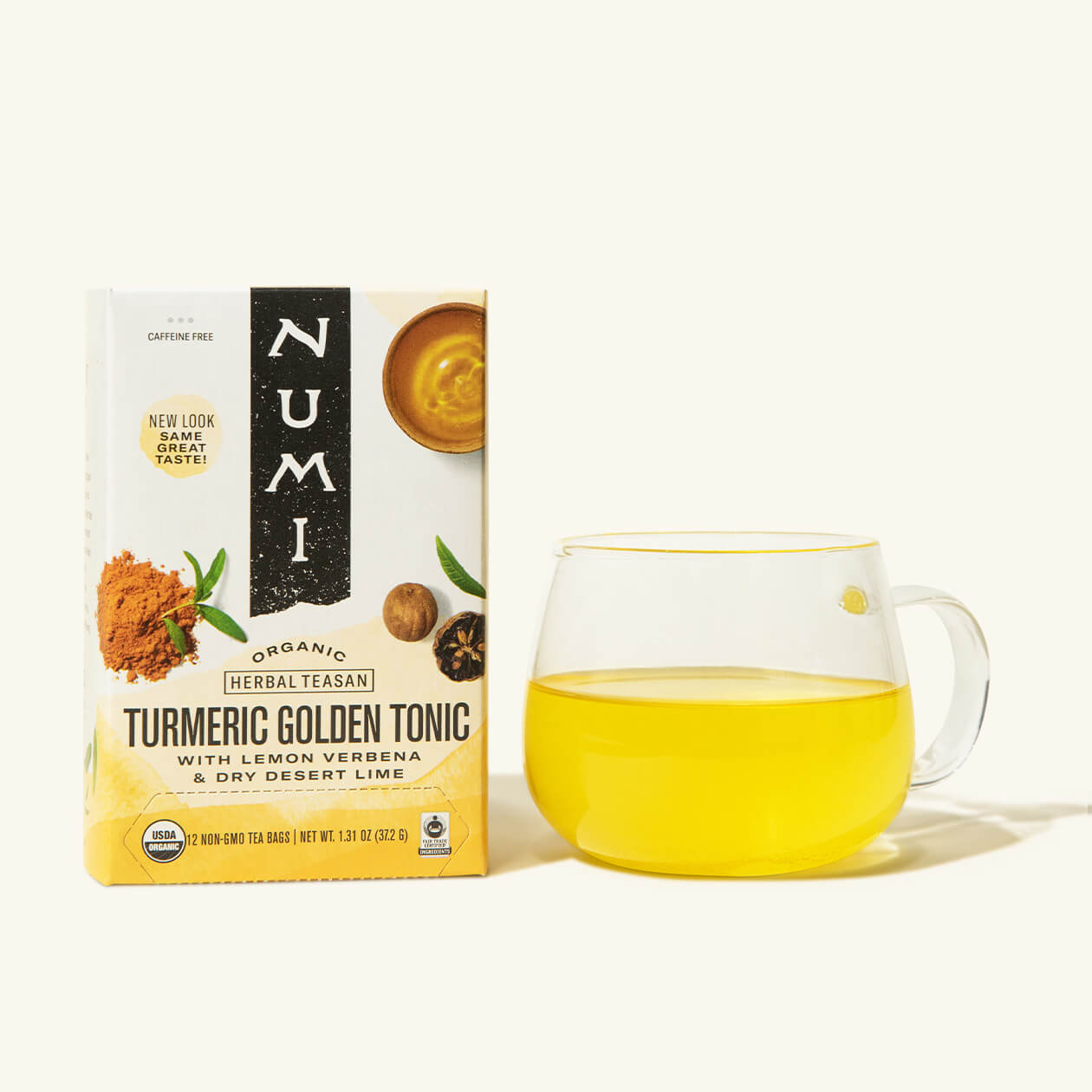 A box of Numi's Golden Tonic next to a brewed cup of tea in a clear cup