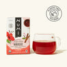 Numi Organic Hibiscus tea box with a glass of red tea on a white background