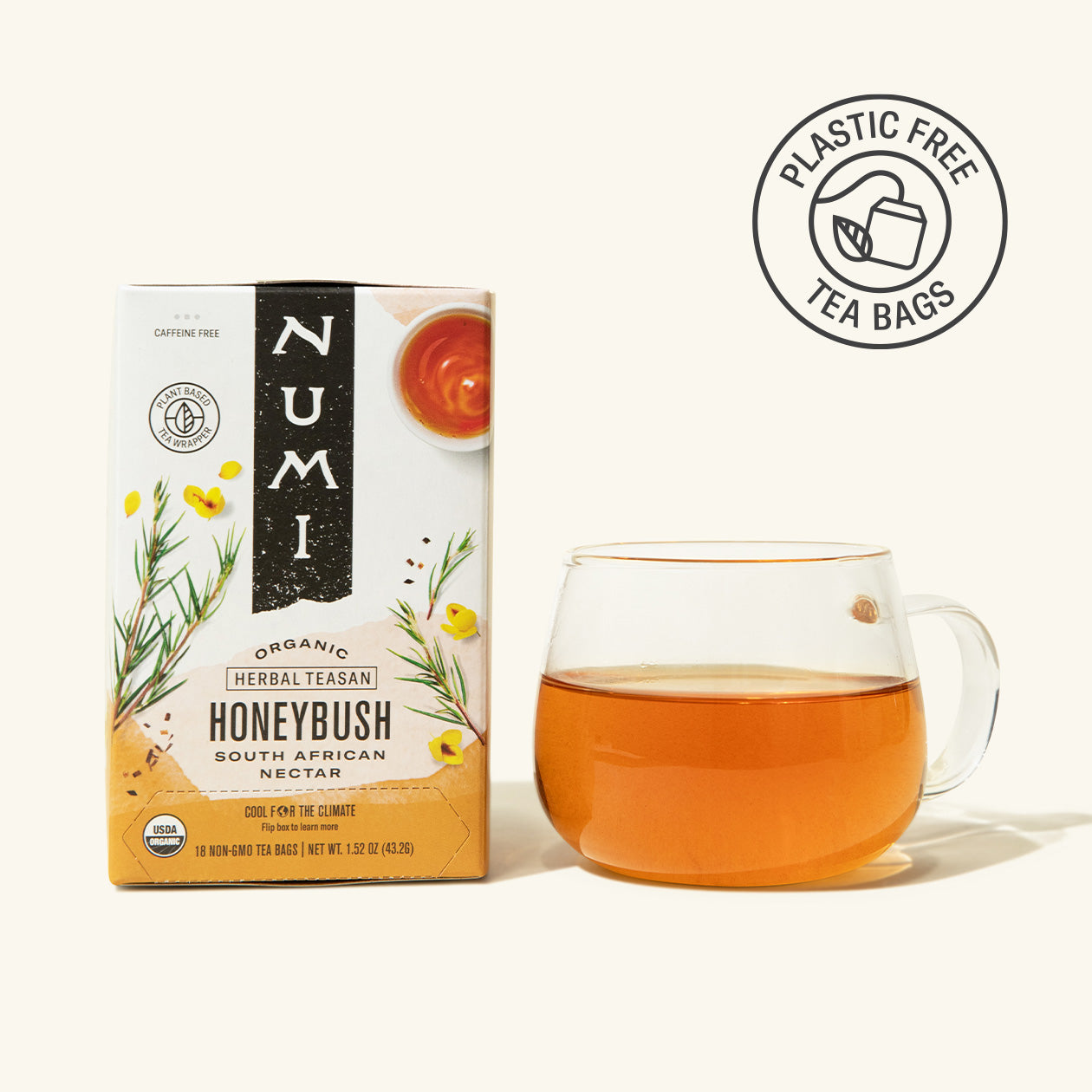 Numi Honeybush tea box with a glass of tea on a white background