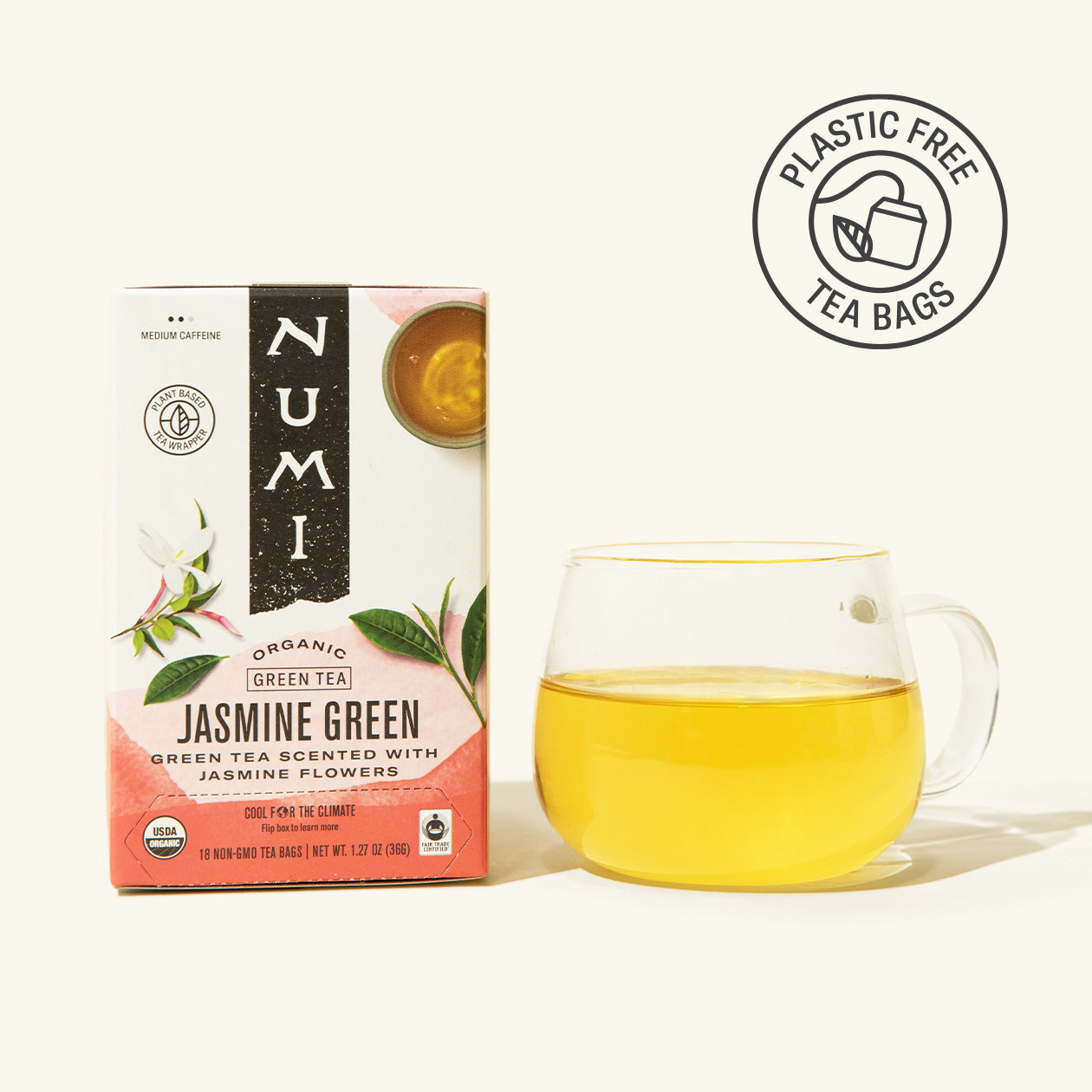 Numi Jasmine Green tea box with a glass of tea on a white background