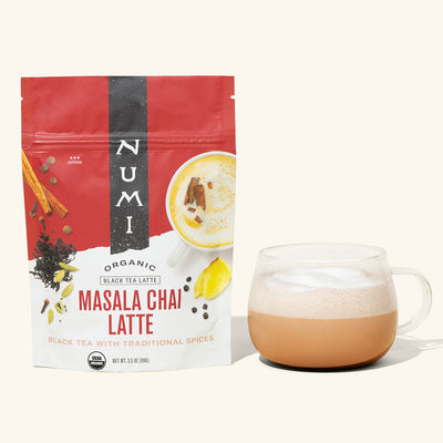 Numi Organic Masala Chai Latte package with a cup of tea on a white background