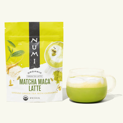 Numi Matcha Maga Latte packaging with a glass of green tea latte on a white background