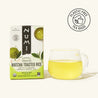 Numi Matcha Toasted Rice tea box with a glass of tea on a white background