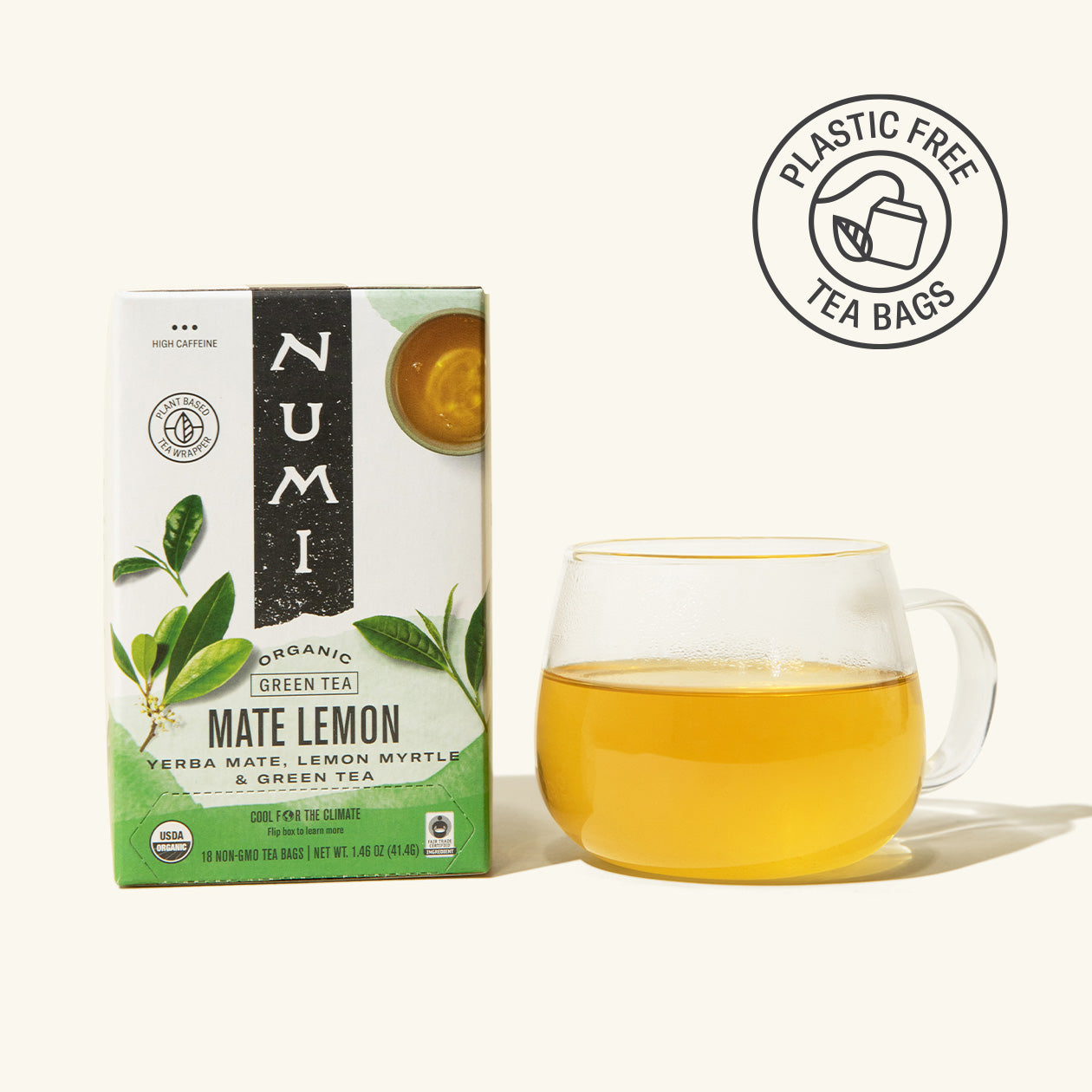 Numi Organic Mate Lemon green tea box with a glass of tea on a white background