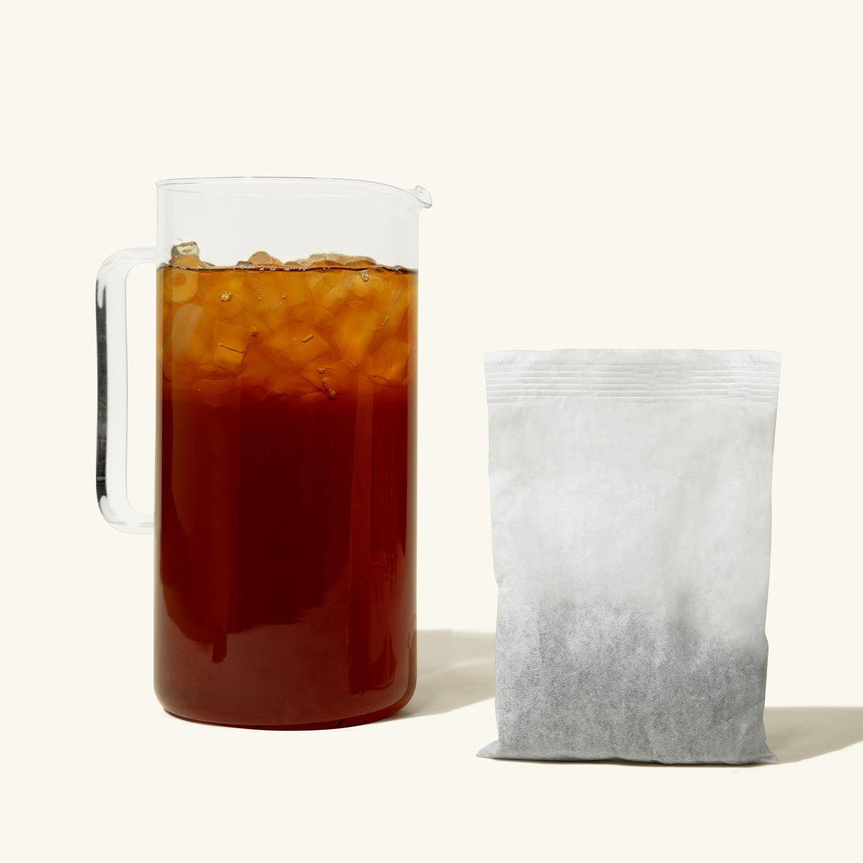 A pitcher of Numi High Mountain Black Iced Tea with a gallon iced tea pouch