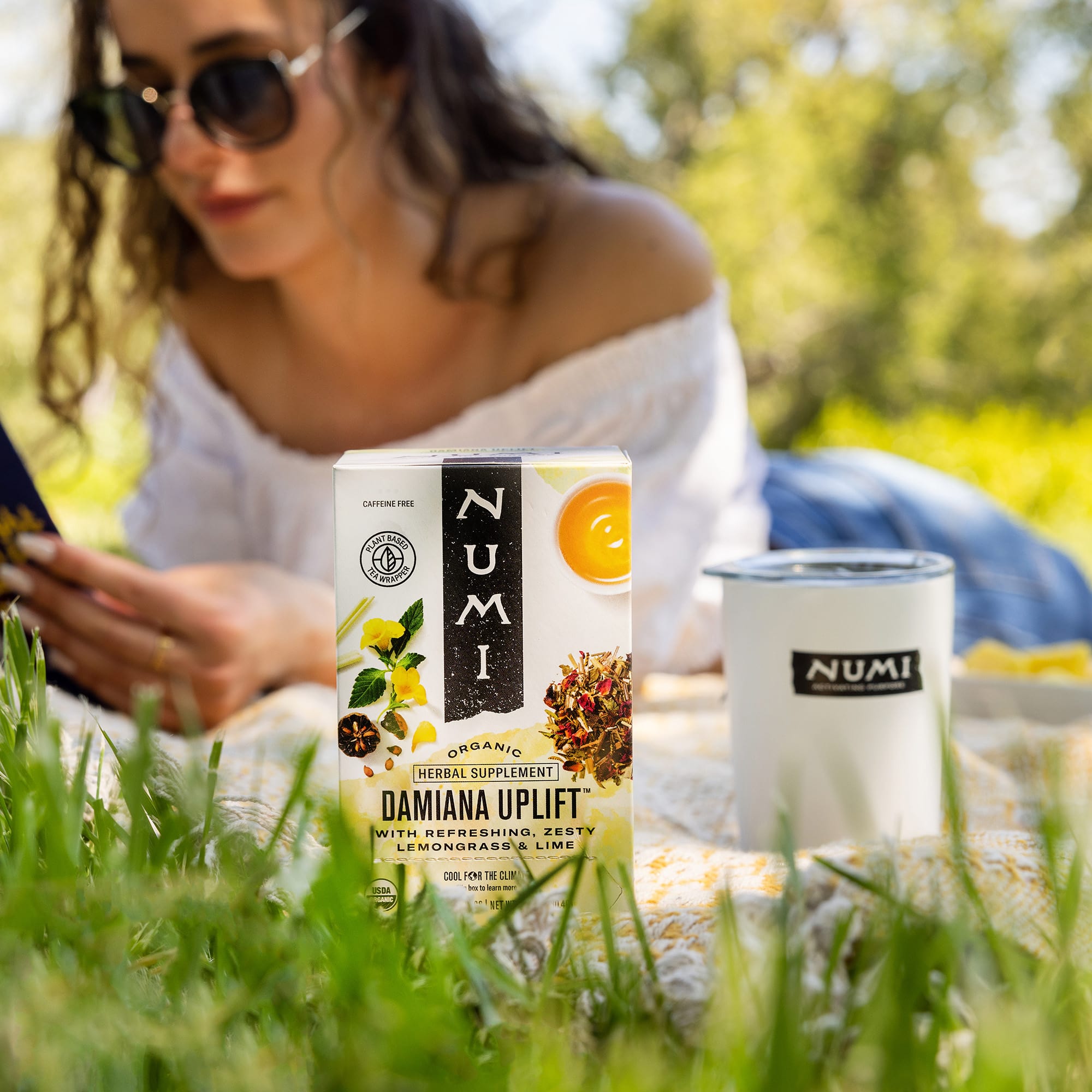 woman reading outside with damiana uplift tea