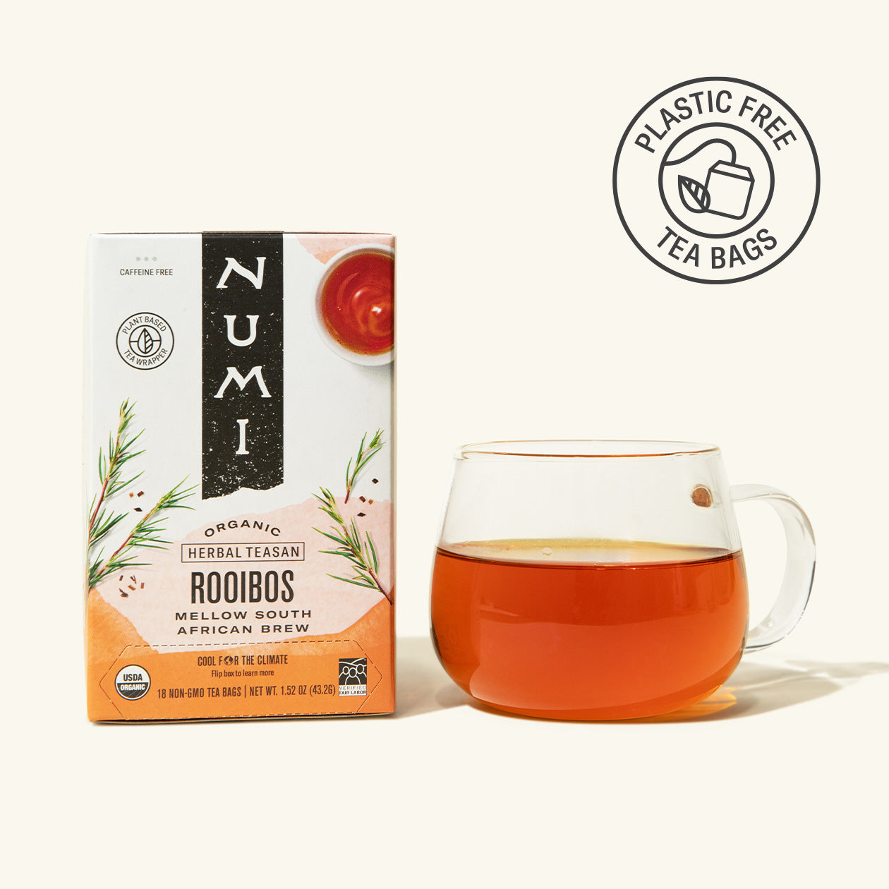 Numi Rooibos tea box with a glass of tea on a white background