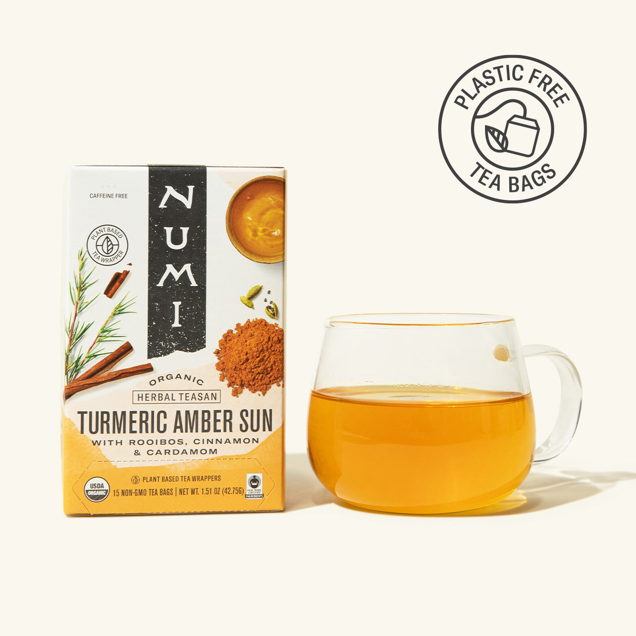 Numi Turmeric Amber Sun tea box with a glass of tea on a white background