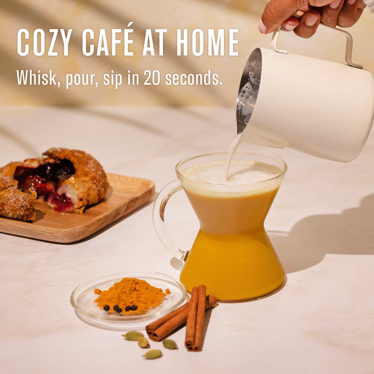 Pouring a hot beverage into a glass carafe with a cozy café ambiance.