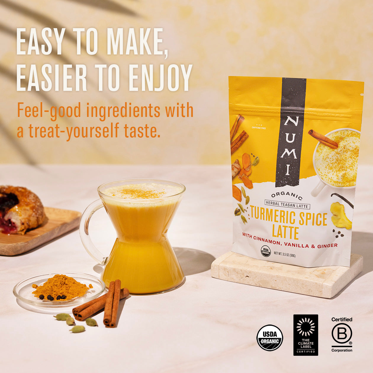 Numi Turmeric Spice Latte package with a glass of latte and ingredients on a light background