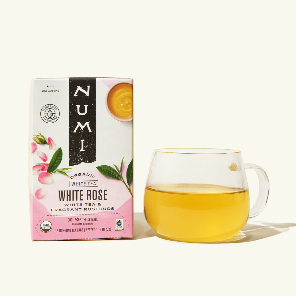A box of Numi's White Rose next to a brewed cup of tea in a clear cup